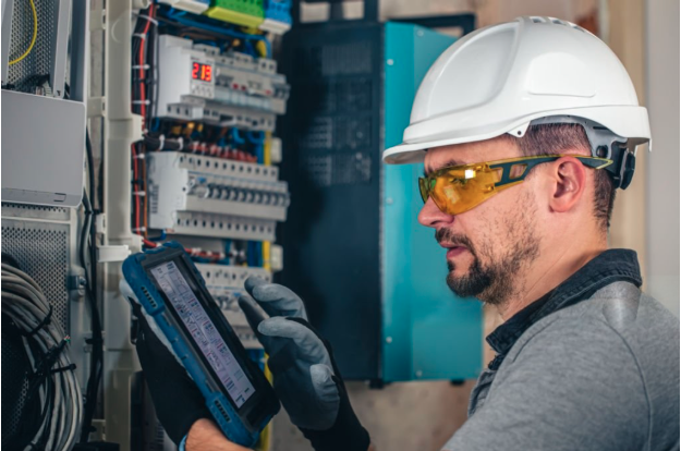 A technician in a Eye protective glasses, hard hat and gloves